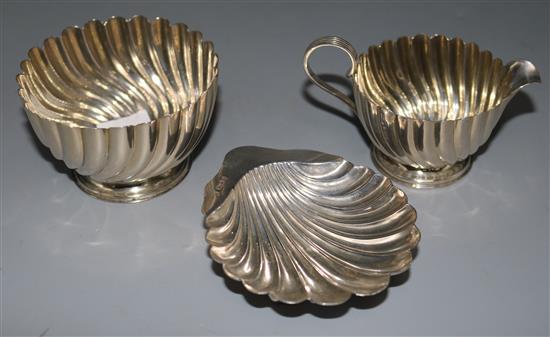 A silver sugar bowl and milk jug and a silver shell shaped butter dish, 5 oz.